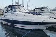 The Image of 2006 Doral Elegante boat docked in a marina with other vessels. - 0