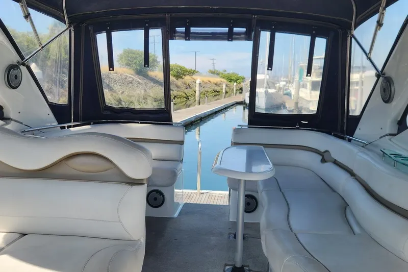 Slide: The Image of Interior of a 2006 Doral Elegante yacht with white seating and a dock view. - 9