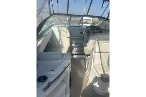 Slide: The Image of 2006 Doral Elegante boat interior with white seating and steering area. - 3