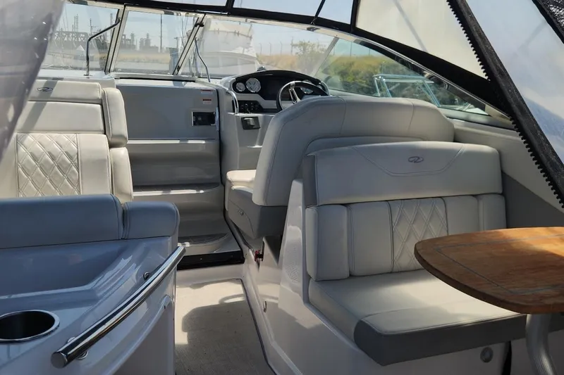 Slide: The Image of Interior of a 2006 Doral Elegante boat with luxurious seating and wooden table. - 10