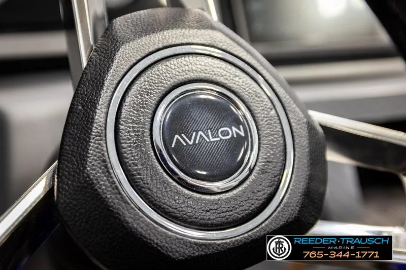 Slide: The Image of Close-up of 2024 Avalon CAT VRB steering wheel with logo detail. - 34