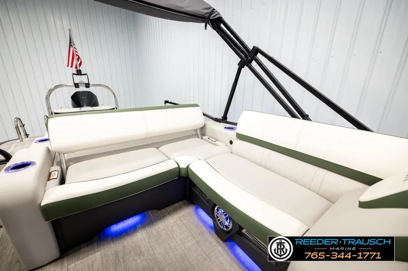 Slide: The Image of 2024 Avalon CAT VRB boat interior with white seating, blue LED lights, and cup holders. - 25