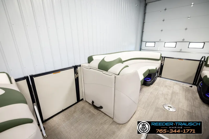 Slide: The Image of 2024 Avalon CAT VRB pontoon interior with green and white seating in a showroom. - 20