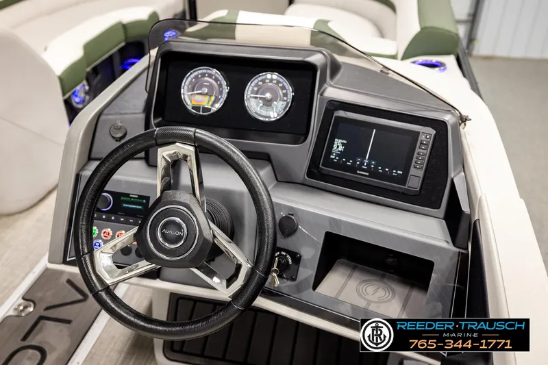 Slide: The Image of 2024 Avalon CAT VRB boat dashboard with steering wheel, gauges, and navigation display. - 32