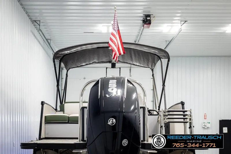 Slide: The Image of 2024 Avalon CAT VRB boat in a garage, featuring a powerful engine and American flag. - 7