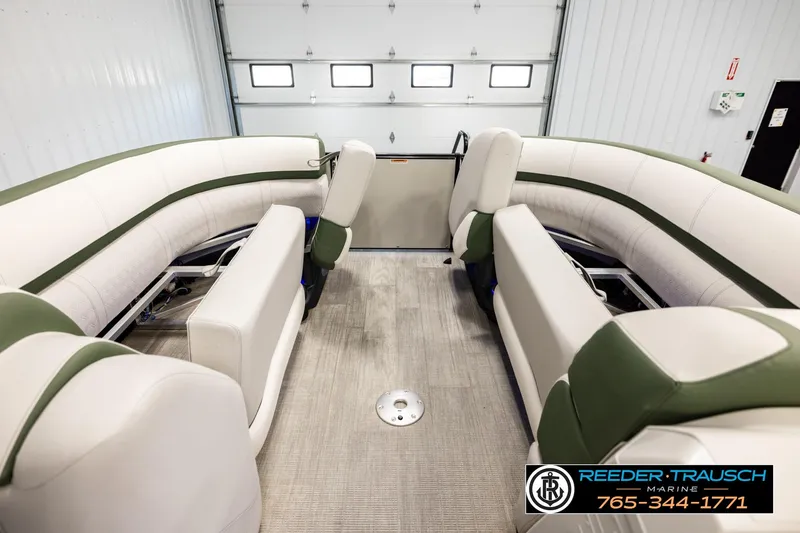 Slide: The Image of 2024 Avalon CAT VRB boat interior with green and white seating in a showroom. - 19