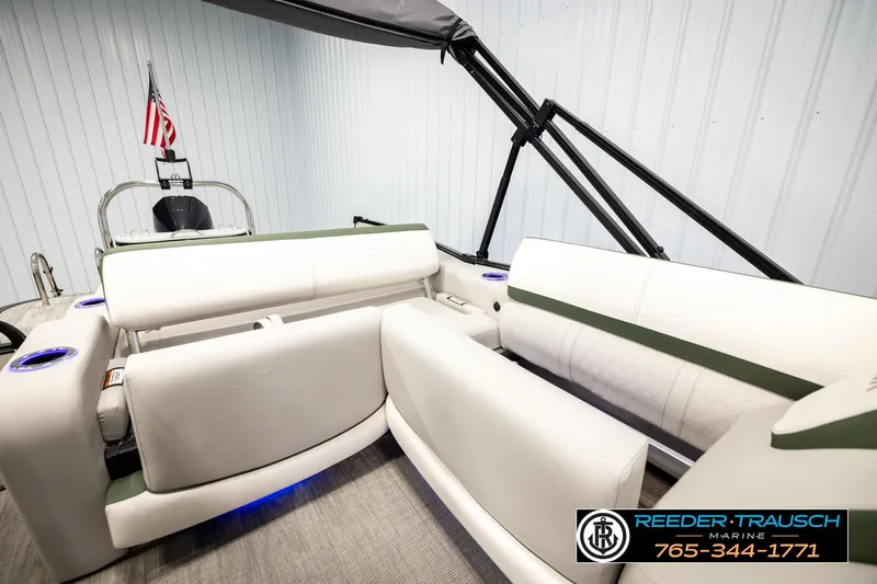 Slide: The Image of 2024 Avalon CAT VRB boat interior with white seating and cup holders, displayed indoors. - 27