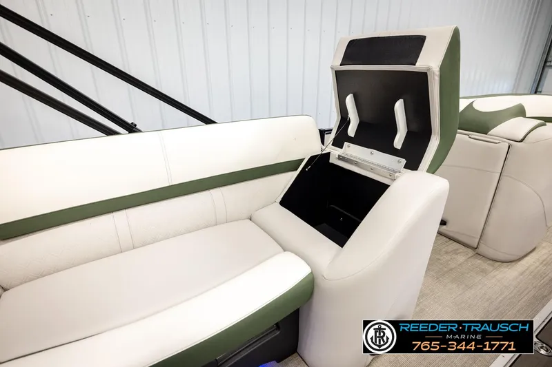 Slide: The Image of 2024 Avalon CAT VRB boat interior with open storage compartment, featuring white and green seating. - 23