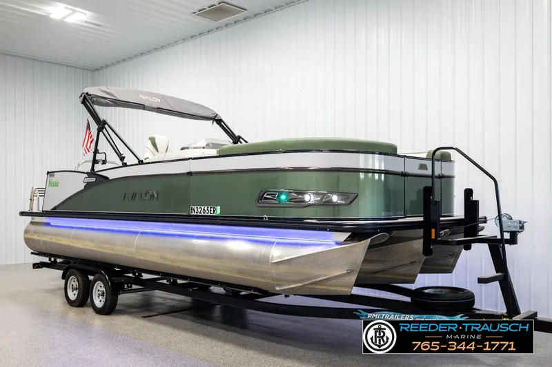 Slide: The Image of 2024 Avalon CAT VRB pontoon boat on trailer in showroom, featuring sleek design and modern amenities. - 2