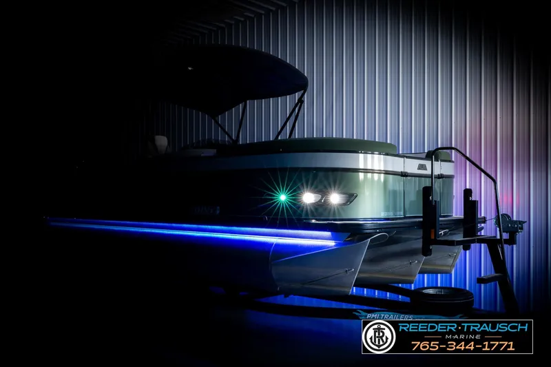 Slide: The Image of 2024 Avalon CAT VRB boat with blue LED lights in a dimly lit showroom. - 4