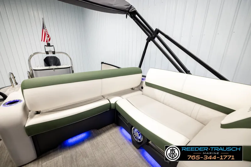 Slide: The Image of 2024 Avalon CAT VRB pontoon boat interior with green and white seating, blue LED lighting. - 26