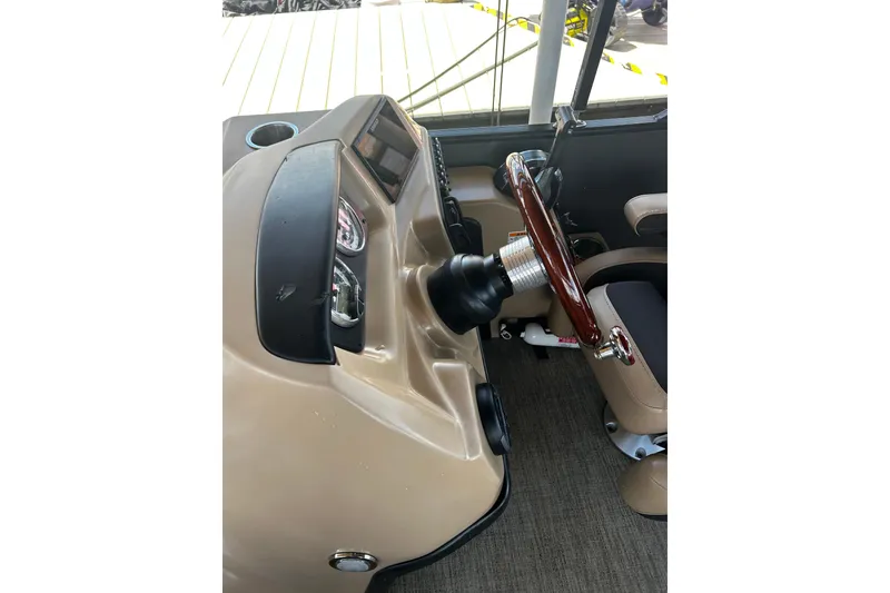 Slide: The Image of 2022 Barletta Cabrio 24UE boat dashboard with steering wheel and controls. - 35