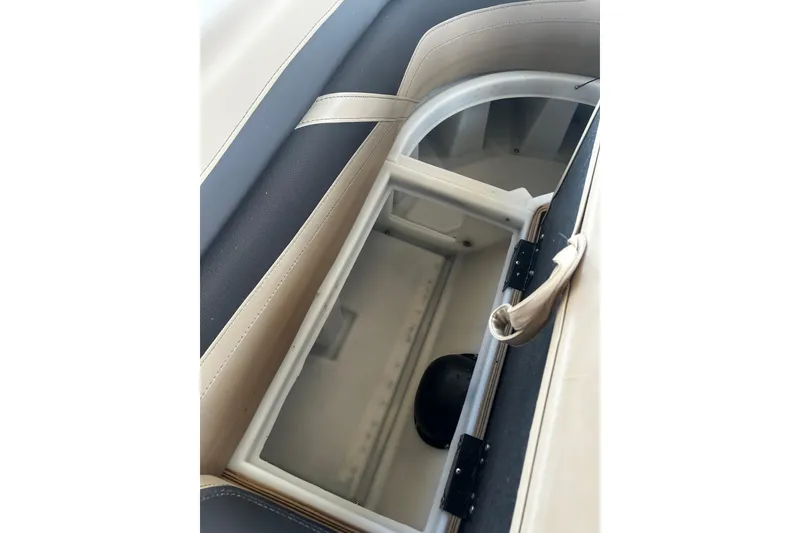 Slide: The Image of Storage compartment in 2022 Barletta Cabrio 24UE boat, featuring beige and black interior. - 46