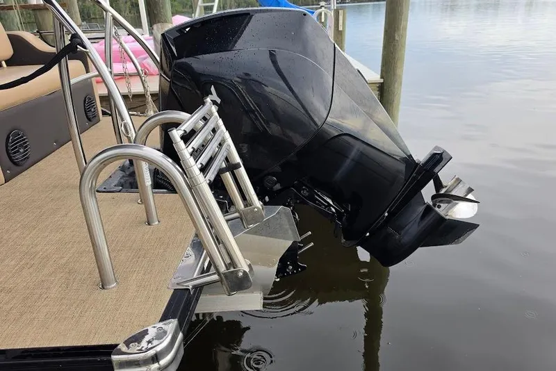 Slide: The Image of 2022 Barletta Cabrio 24UE boat with outboard motor and swim ladder at dock. - 23