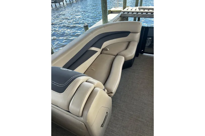 Slide: The Image of Luxurious seating on 2022 Barletta Cabrio 24UE pontoon boat by the water. - 40