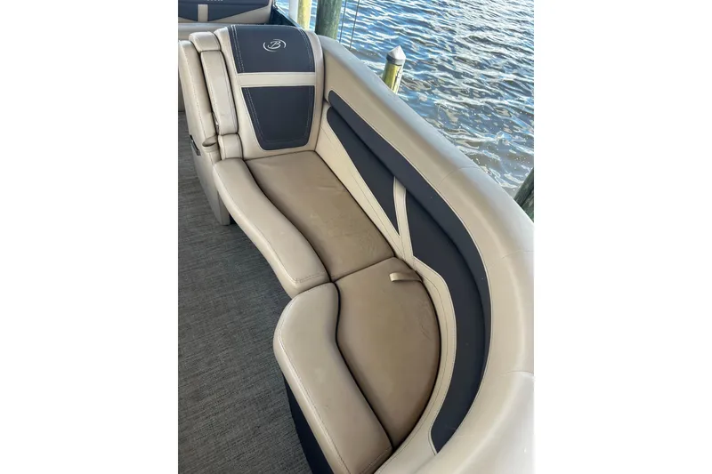 Slide: The Image of Luxurious seating on 2022 Barletta Cabrio 24UE pontoon boat by the water. - 39