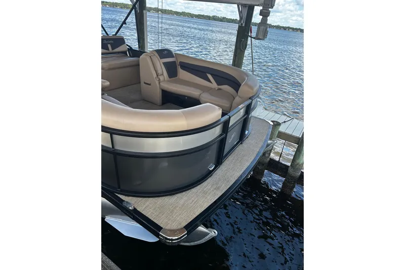 Slide: The Image of 2022 Barletta Cabrio 24UE pontoon boat docked by the water. - 32
