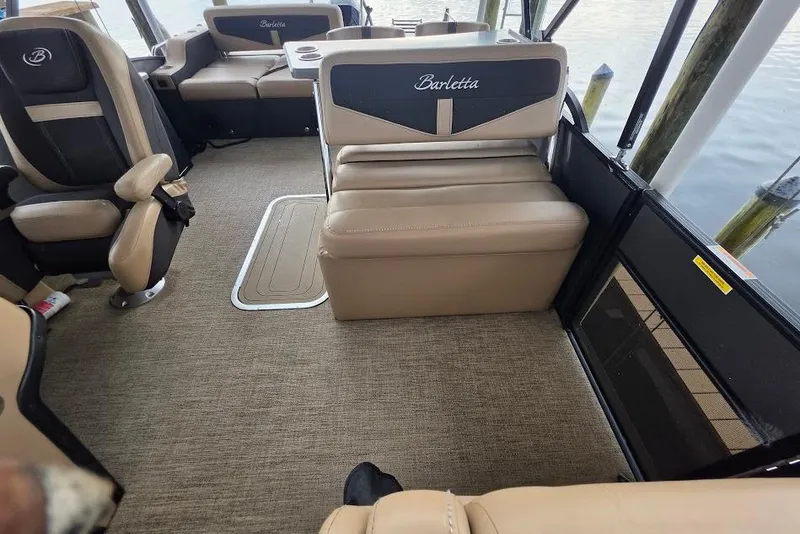 Slide: The Image of Interior of a 2022 Barletta Cabrio 24UE pontoon boat with beige seating. - 19