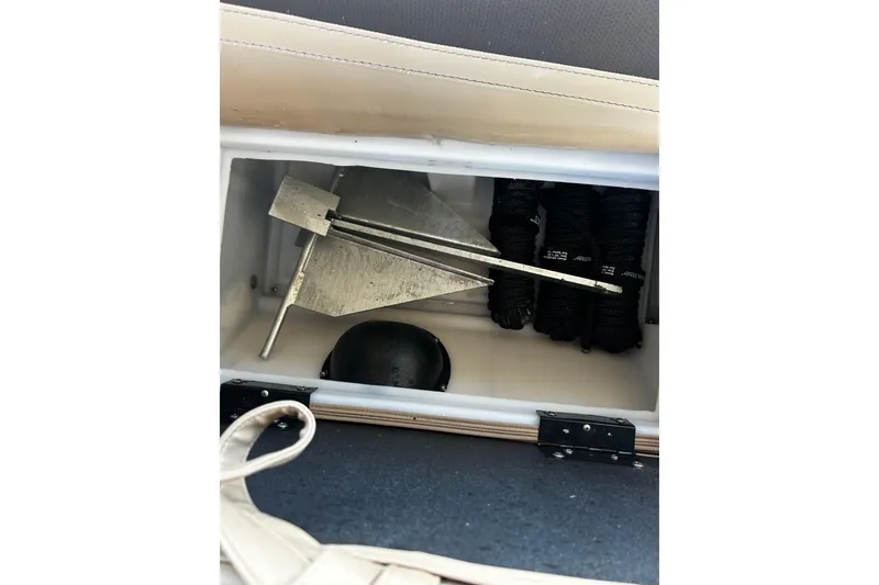 Slide: The Image of Storage compartment in a 2022 Barletta Cabrio 24UE with anchor and ropes. - 43