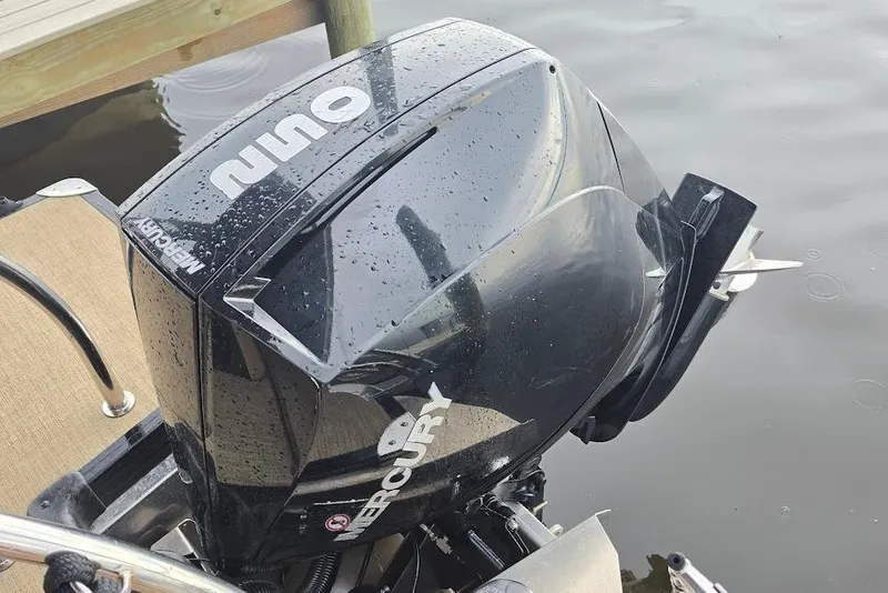 Slide: The Image of Mercury outboard motor on a 2022 Barletta Cabrio 24UE pontoon boat by the water. - 26