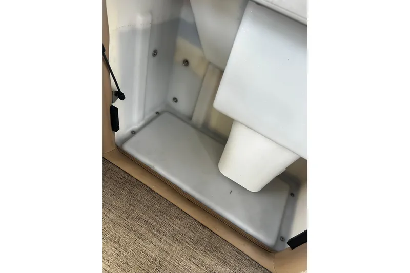 Slide: The Image of Interior compartment of 2022 Barletta Cabrio 24UE boat, featuring white and beige materials. - 45