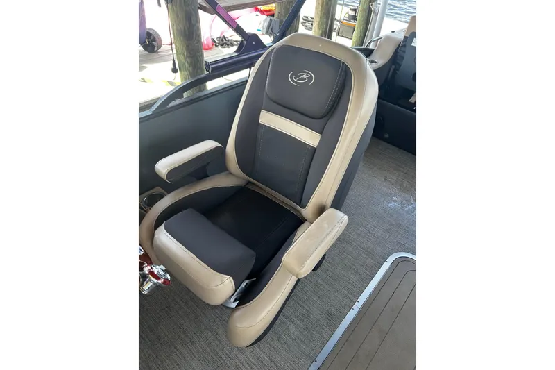 Slide: The Image of Captain's chair on 2022 Barletta Cabrio 24UE pontoon boat, featuring beige and black upholstery. - 34