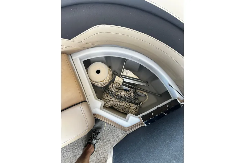 Slide: The Image of Storage compartment in 2022 Barletta Cabrio 24UE boat with rope and anchor. - 44