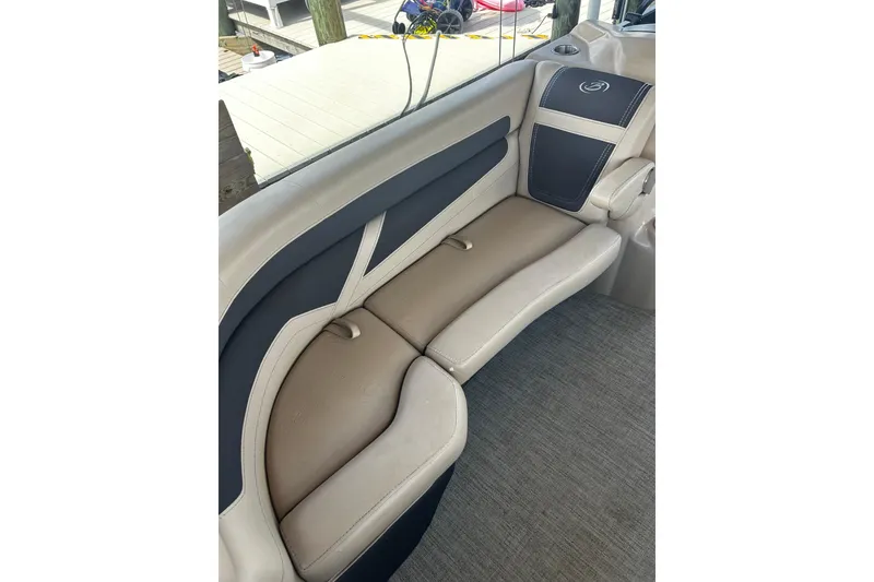 Slide: The Image of 2022 Barletta Cabrio 24UE boat interior with beige and black seating. - 38