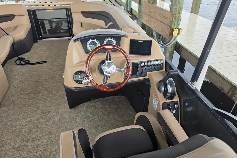 Slide: The Image of Interior view of 2022 Barletta Cabrio 24UE pontoon boat with steering console. - 12