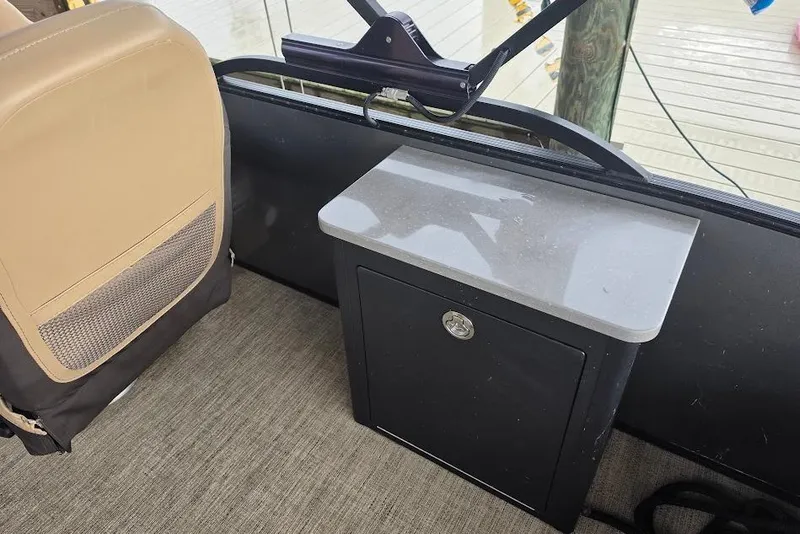 Slide: The Image of Interior of 2022 Barletta Cabrio 24UE with beige seat and storage compartment. - 22