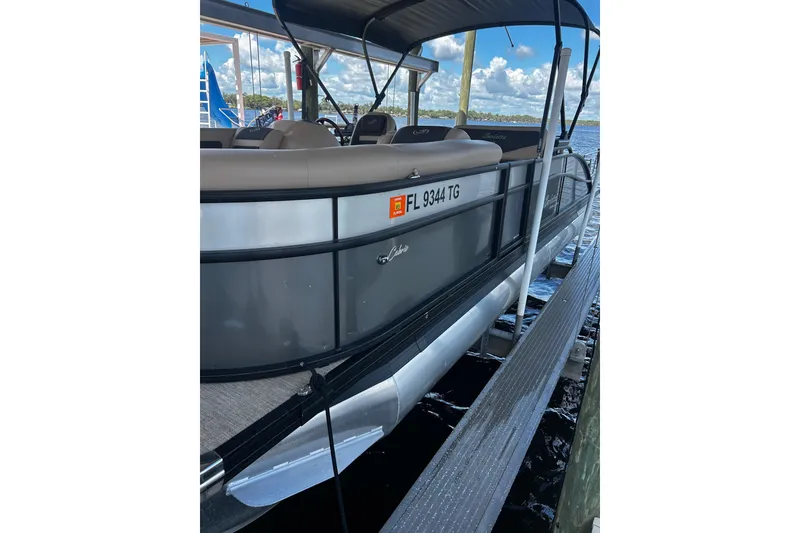 Slide: The Image of 2022 Barletta Cabrio 24UE pontoon boat docked by the water. - 4