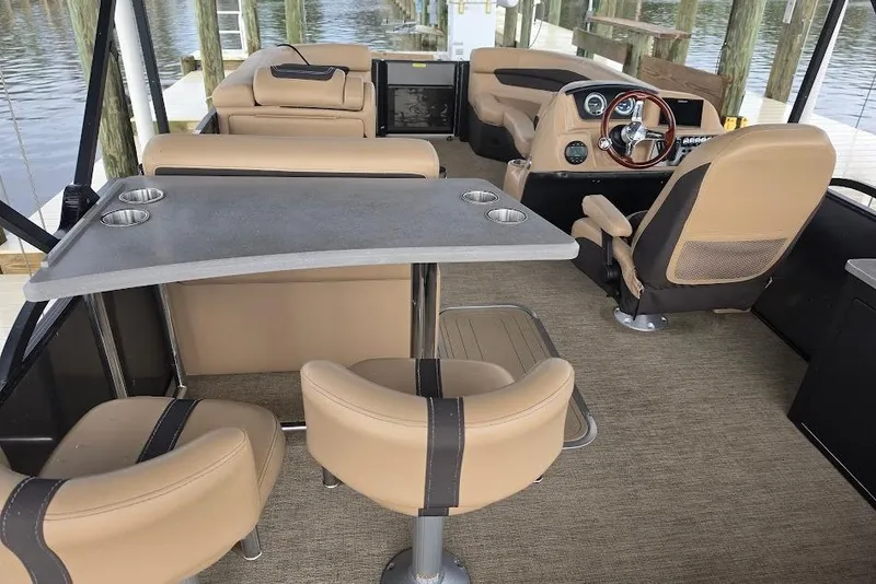 Slide: The Image of Interior of 2022 Barletta Cabrio 24UE pontoon boat with beige seating and helm. - 15