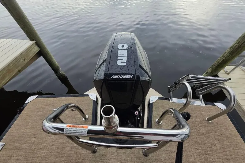Slide: The Image of 2022 Barletta Cabrio 24UE boat with Mercury outboard motor at dock. - 25