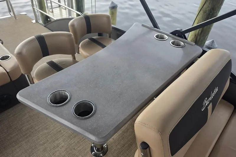 Slide: The Image of Barletta Cabrio 24UE 2022 boat interior with table and cup holders. - 16