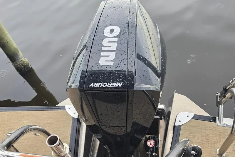 Slide: The Image of Mercury outboard motor on 2022 Barletta Cabrio 24UE pontoon boat, docked on water. - 27