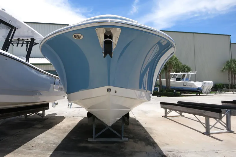 Slide: The Image of 2026 Robalo R250 Center Console boat on display in a marina setting. - 4