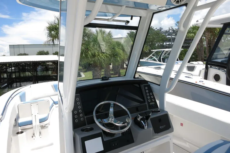Slide: The Image of 2026 Robalo R250 Center Console boat interior with steering wheel and dashboard. - 16