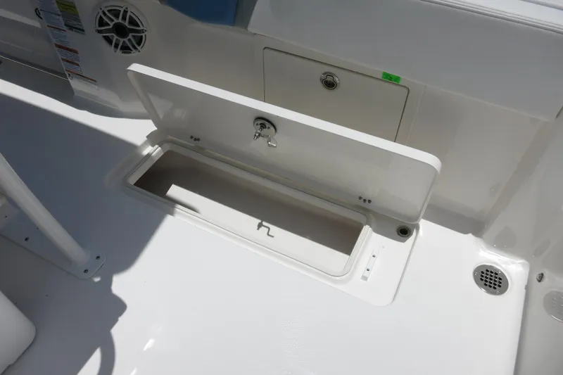 Slide: The Image of 2026 Robalo R250 Center Console boat storage compartment with open hatch. - 23
