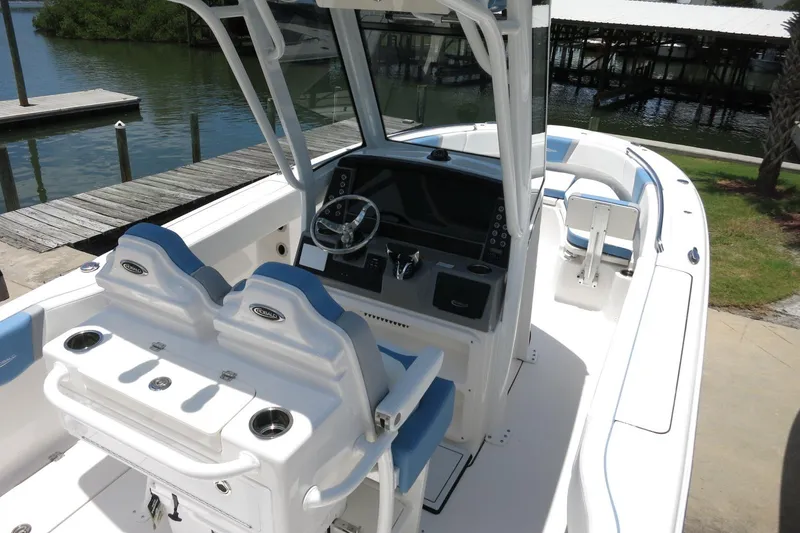Slide: The Image of 2026 Robalo R250 Center Console boat with sleek design and modern dashboard. - 12