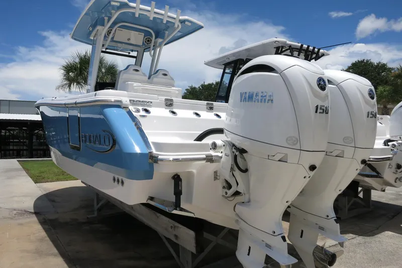 Slide: The Image of 2026 Robalo R250 Center Console boat with twin Yamaha 150 engines, docked outdoors. - 8