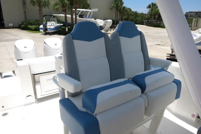 Slide: The Image of 2026 Robalo R250 Center Console boat seats, featuring blue and white upholstery. - 25