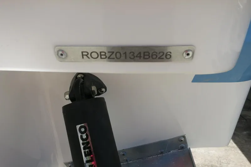 Slide: The Image of 2026 Robalo R250 Center Console boat with visible serial number and Lenco trim tab. - 36