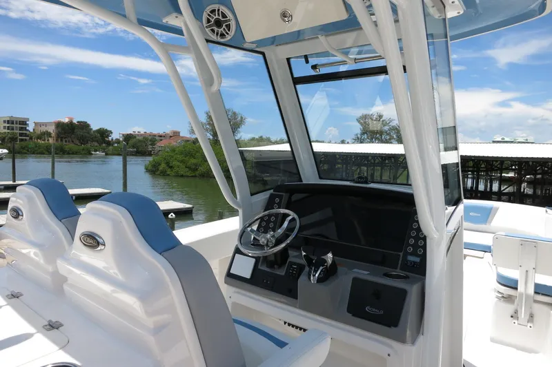 Slide: The Image of 2026 Robalo R250 Center Console boat interior with dual seats and modern dashboard. - 19
