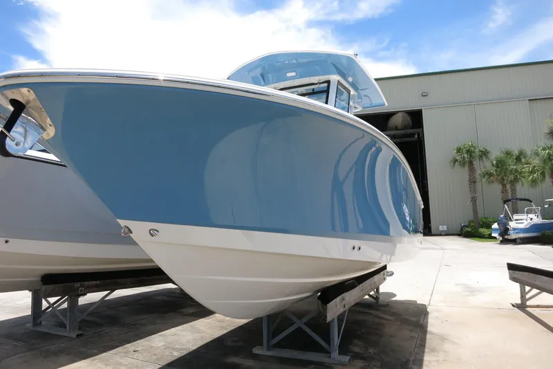 Slide: The Image of 2026 Robalo R250 Center Console boat displayed outdoors on a sunny day. - 3