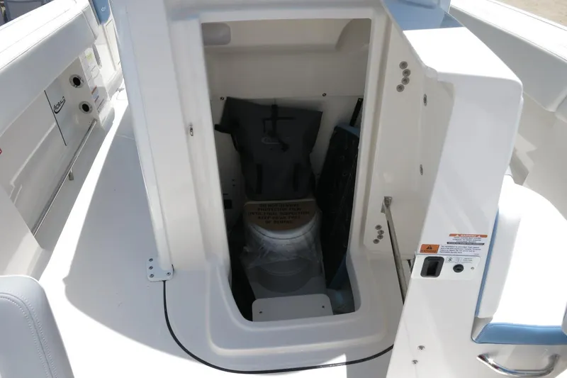 Slide: The Image of 2026 Robalo R250 Center Console boat storage compartment with safety equipment. - 32