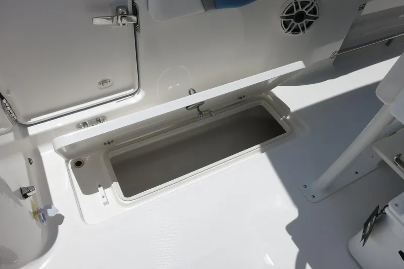 Slide: The Image of 2026 Robalo R250 Center Console boat storage compartment open on deck. - 22