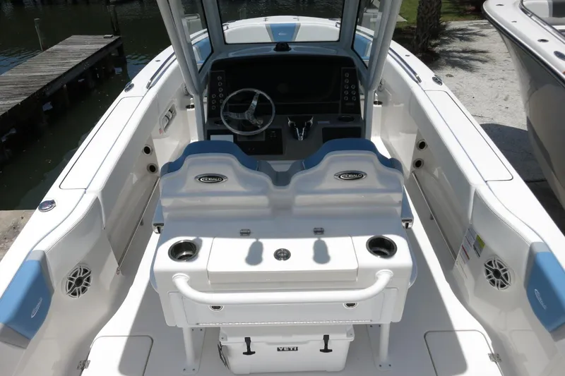 Slide: The Image of 2026 Robalo R250 Center Console boat interior with helm and seating area. - 11