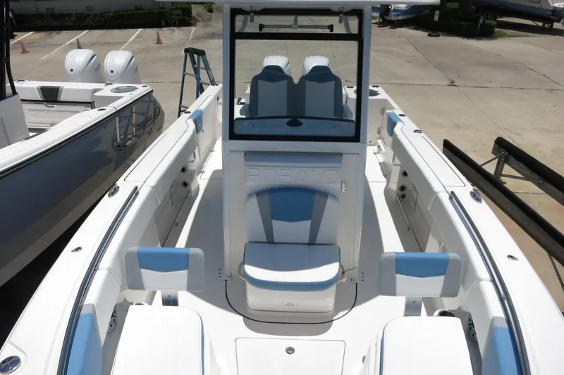 Slide: The Image of 2026 Robalo R250 Center Console boat with sleek white and blue seating. - 35