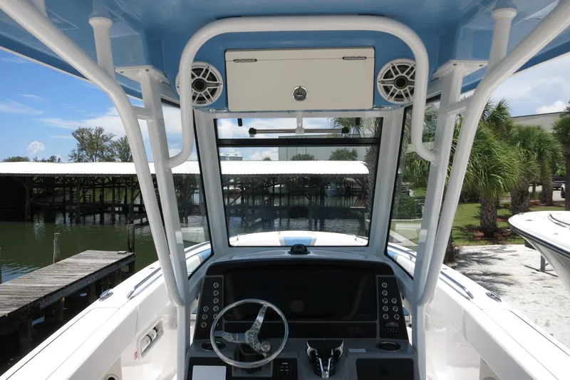 Slide: The Image of 2026 Robalo R250 Center Console boat interior with steering wheel and control panel. - 17