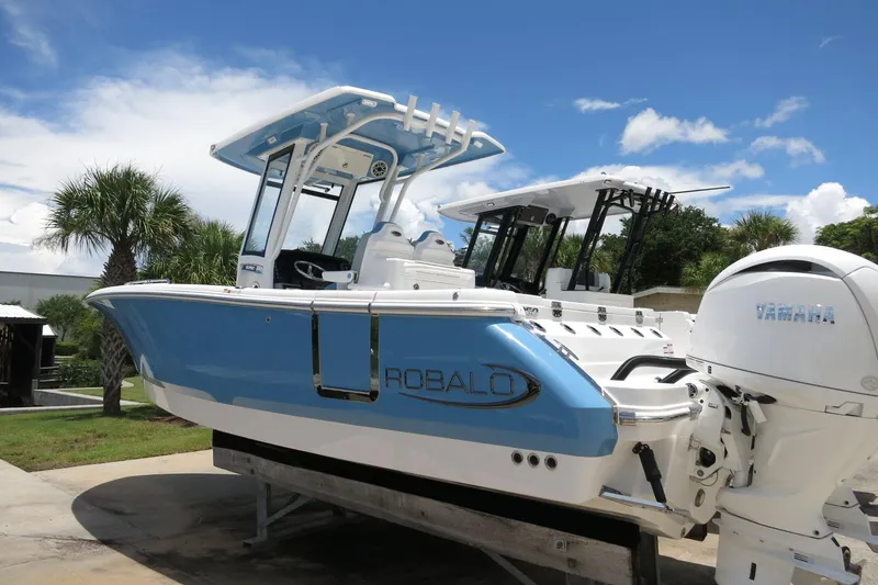 Slide: The Image of 2026 Robalo R250 Center Console boat with Yamaha engine, displayed outdoors. - 7